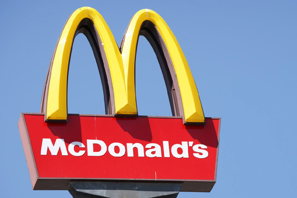 Close-up McDonalds outdoor sign against blue sky